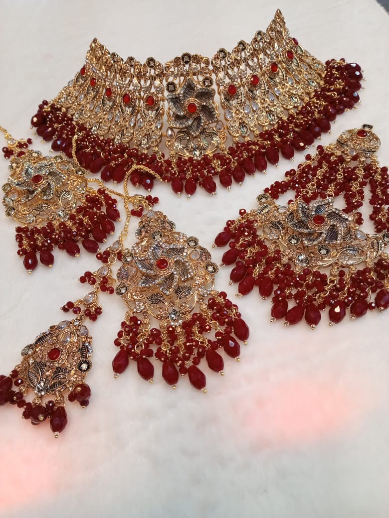 Bridal collar necklace set with red stones and gold floral detailing